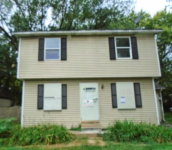 a side view of a house with a garage