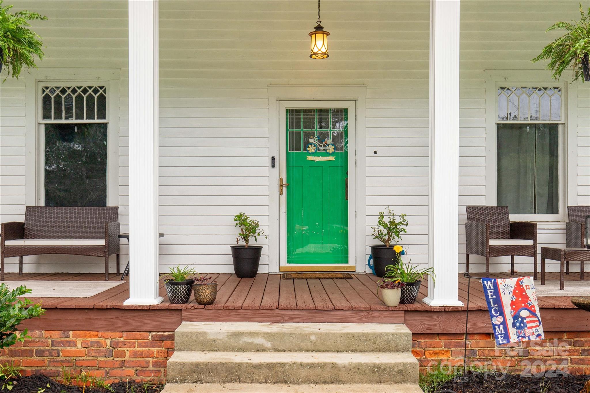 a front view of a house with outdoor seating