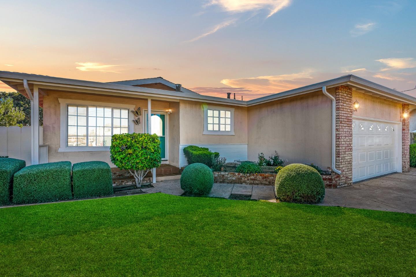 a view of a house with a backyard and a garden