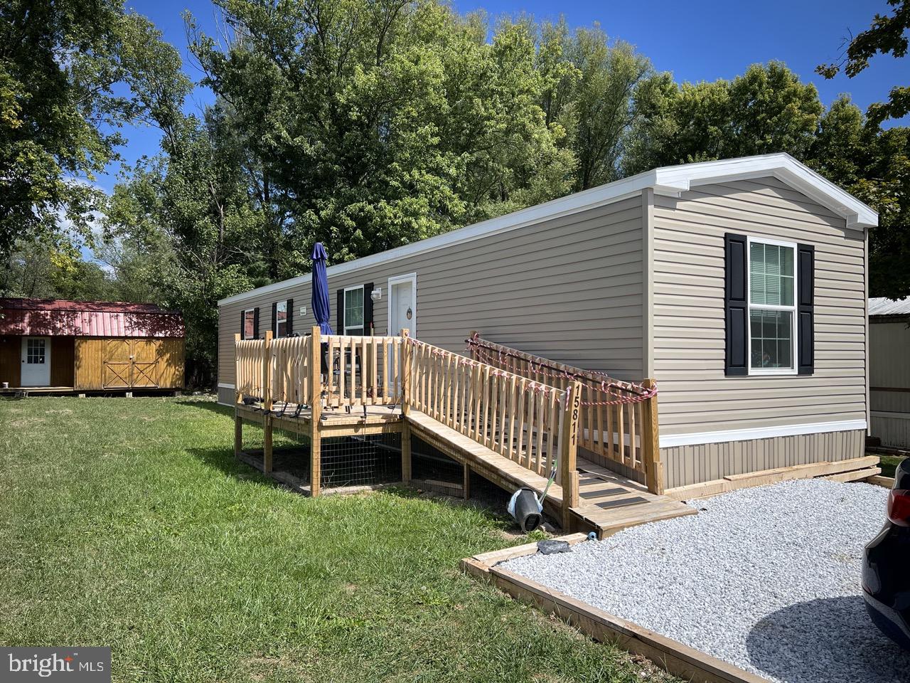 a view of a house with a yard and deck