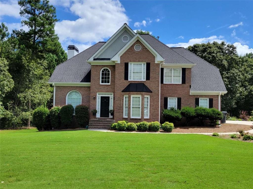 a front view of a house with a yard