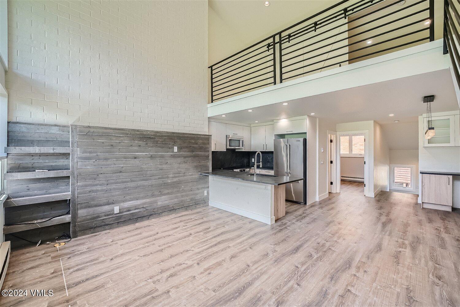 a kitchen with stainless steel appliances kitchen island granite countertop a stove and a refrigerator