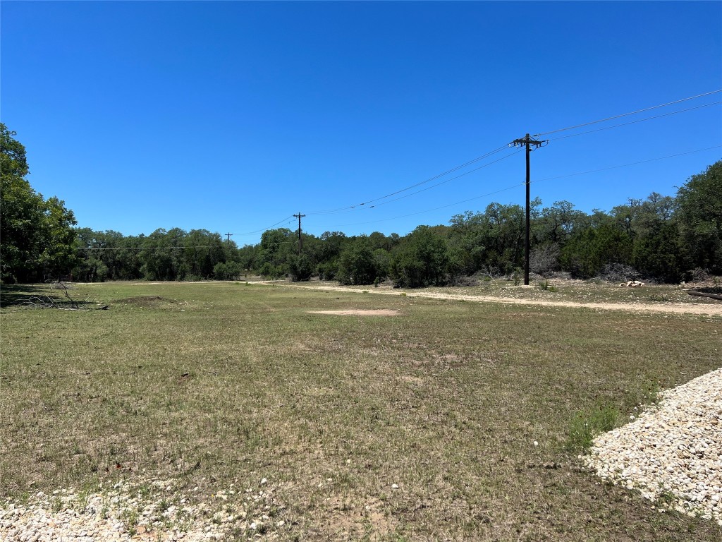 a view of a field with trees in background