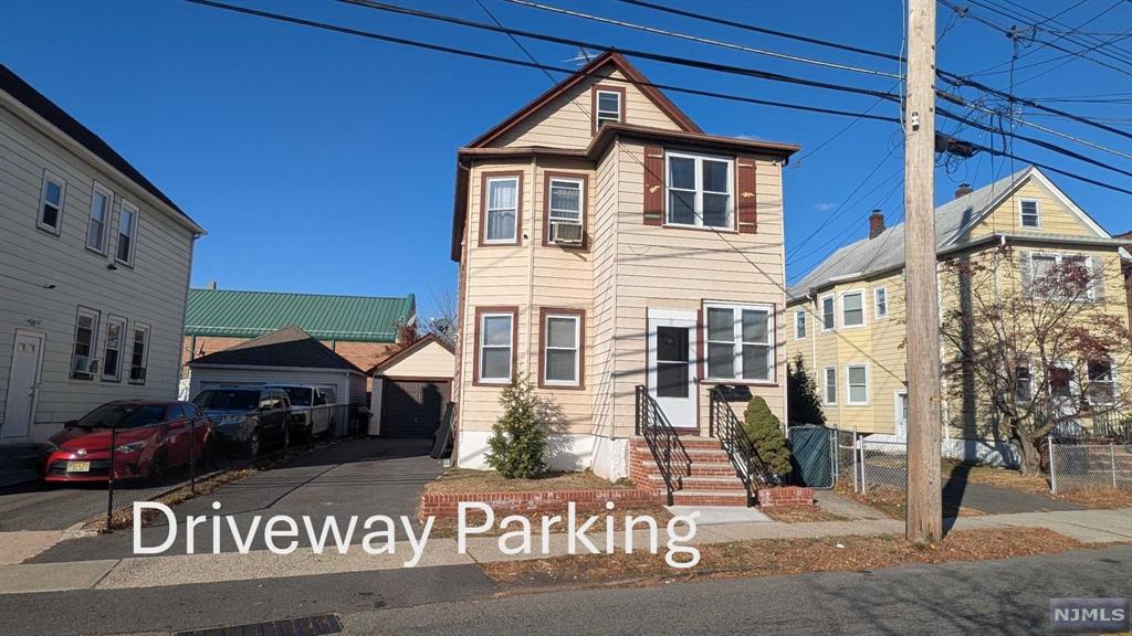 a front view of a house with parking area