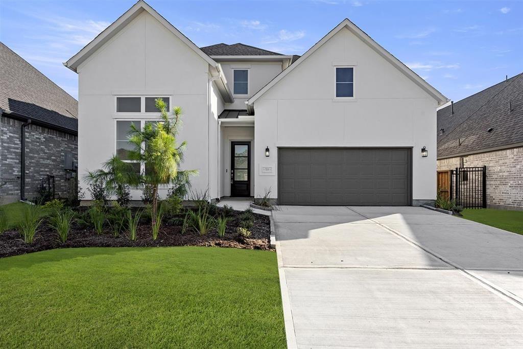 a front view of house with yard and outdoor seating