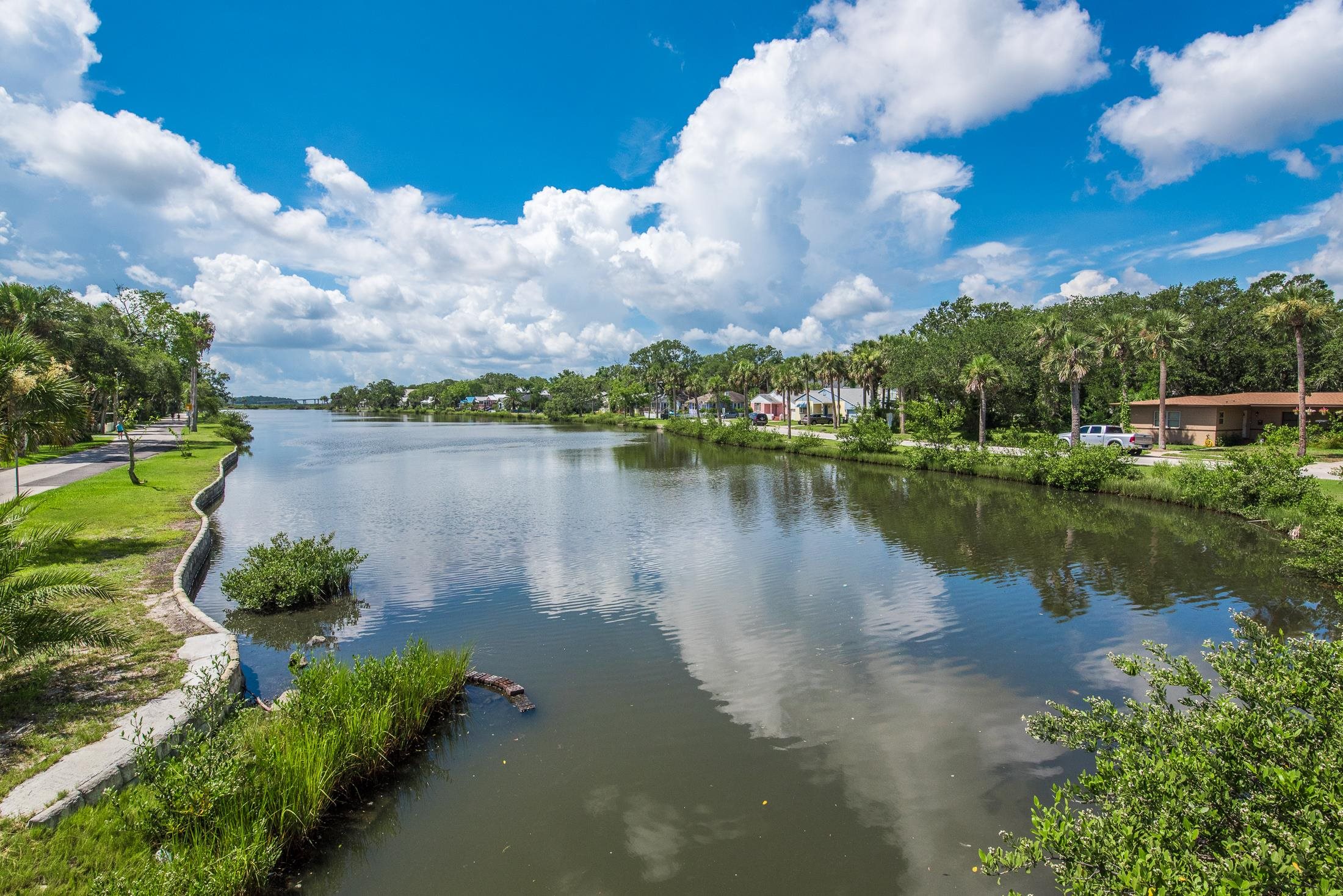 a view of a lake with houses in the back