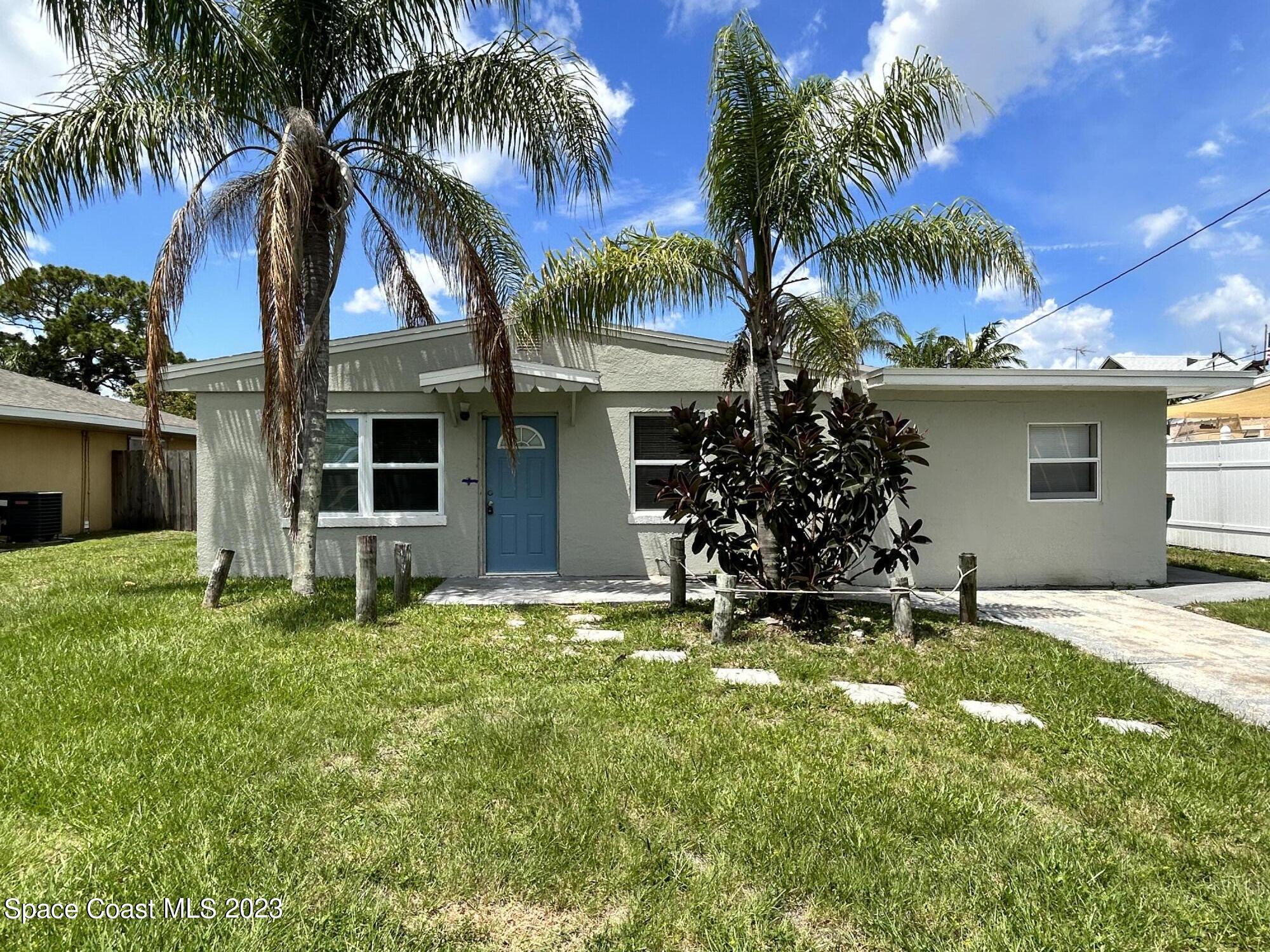 a house with palm tree in front of it