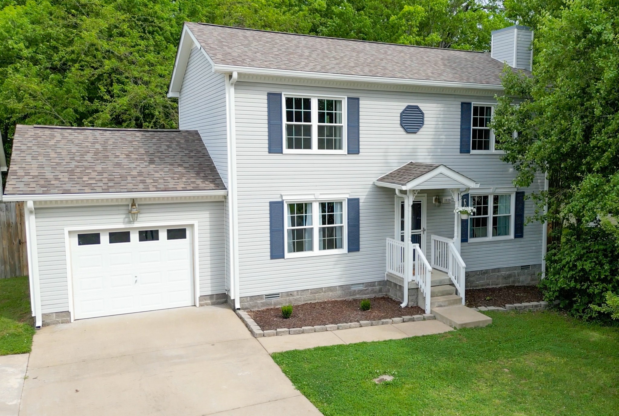 a front view of a house with a yard fire pit and outdoor seating