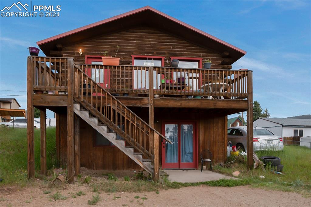 a view of house with deck and outdoor seating