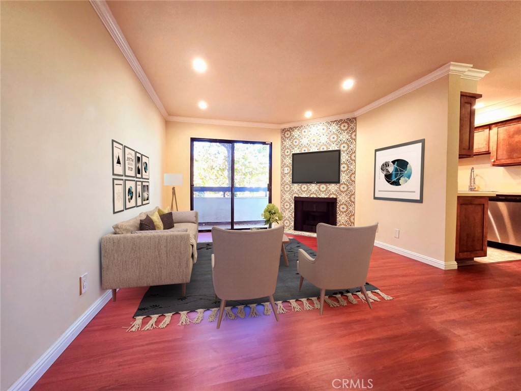 a living room with furniture wooden floor and a fireplace