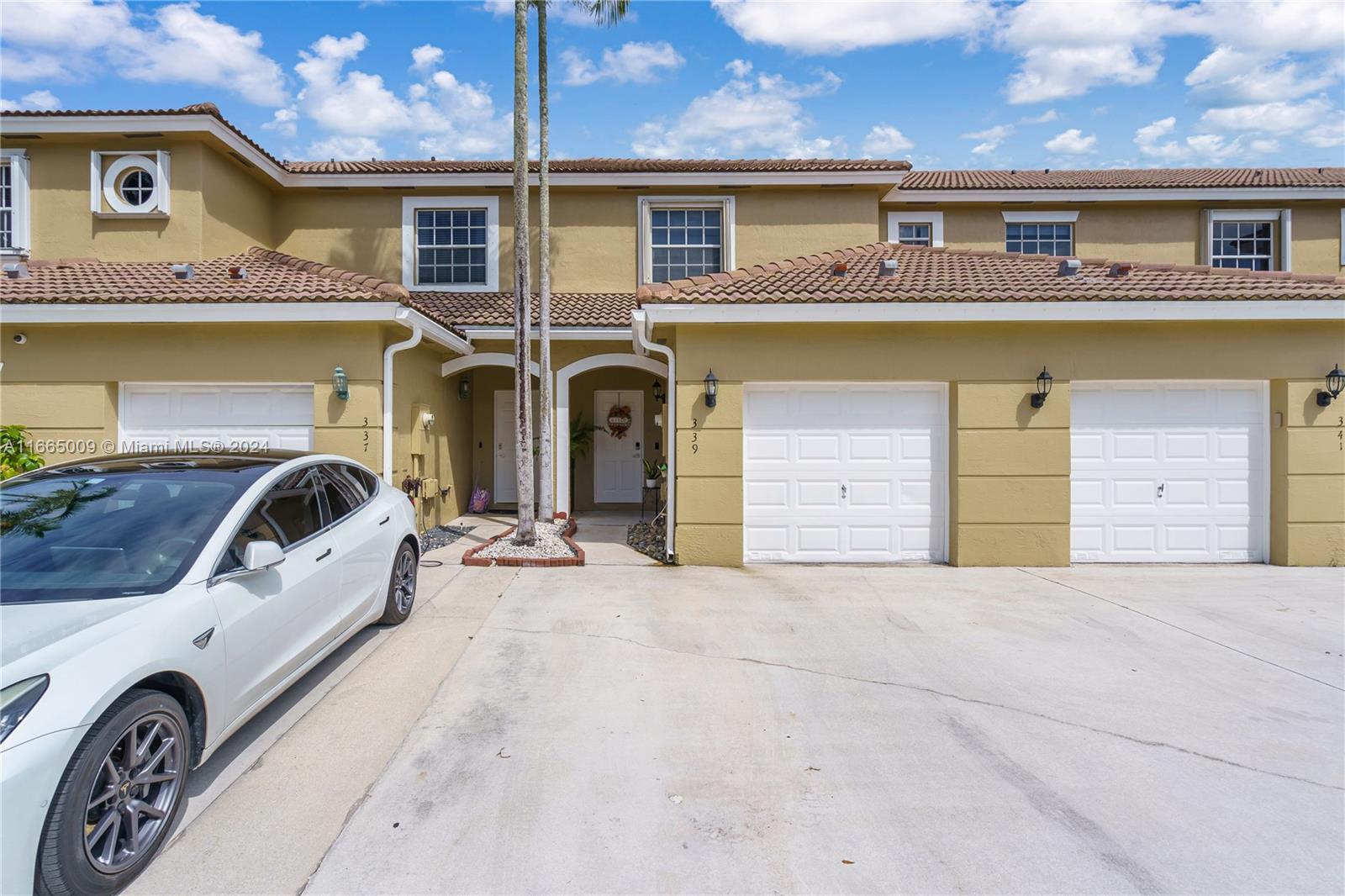 a front view of a house with parking area