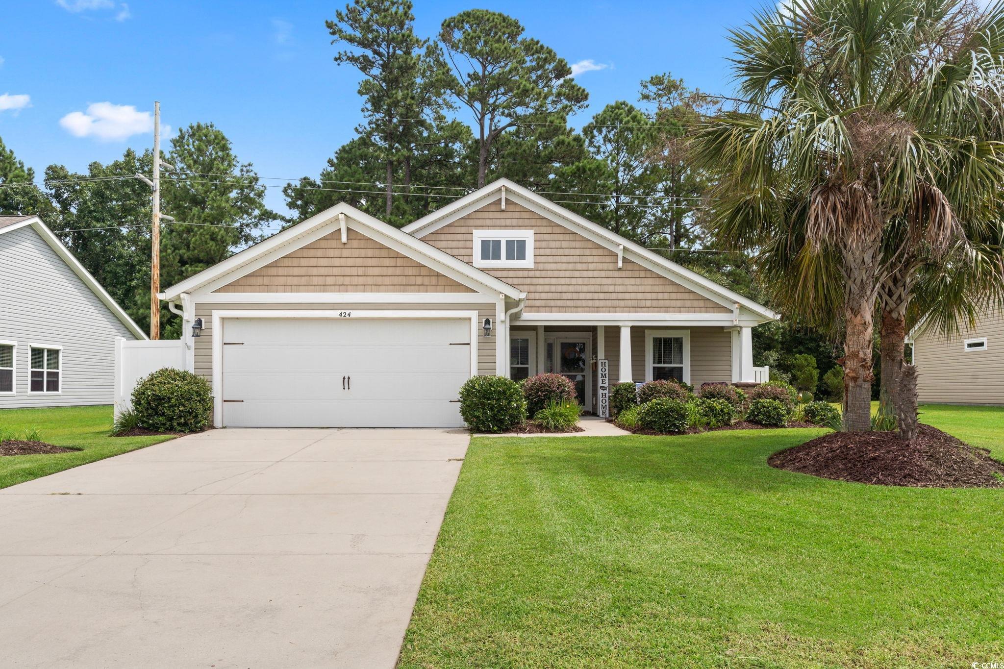 Craftsman-style home with a garage and a front law