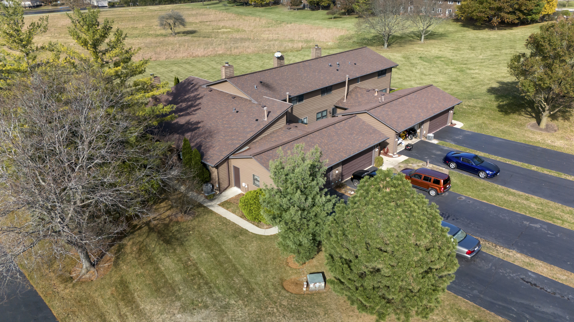 an aerial view of a house with a yard