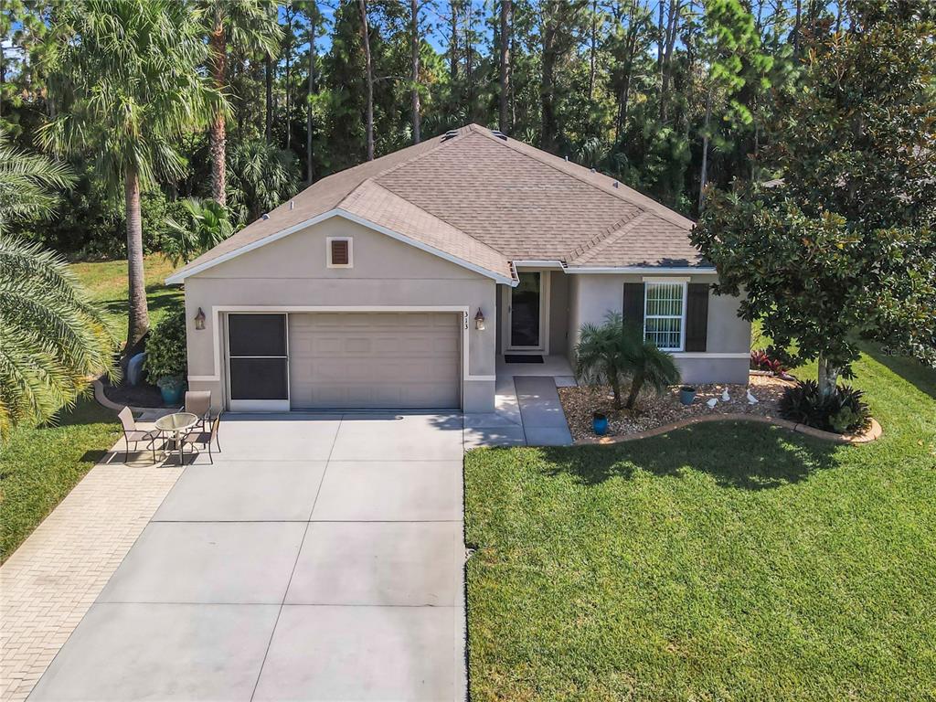 a front view of house with yard and green space