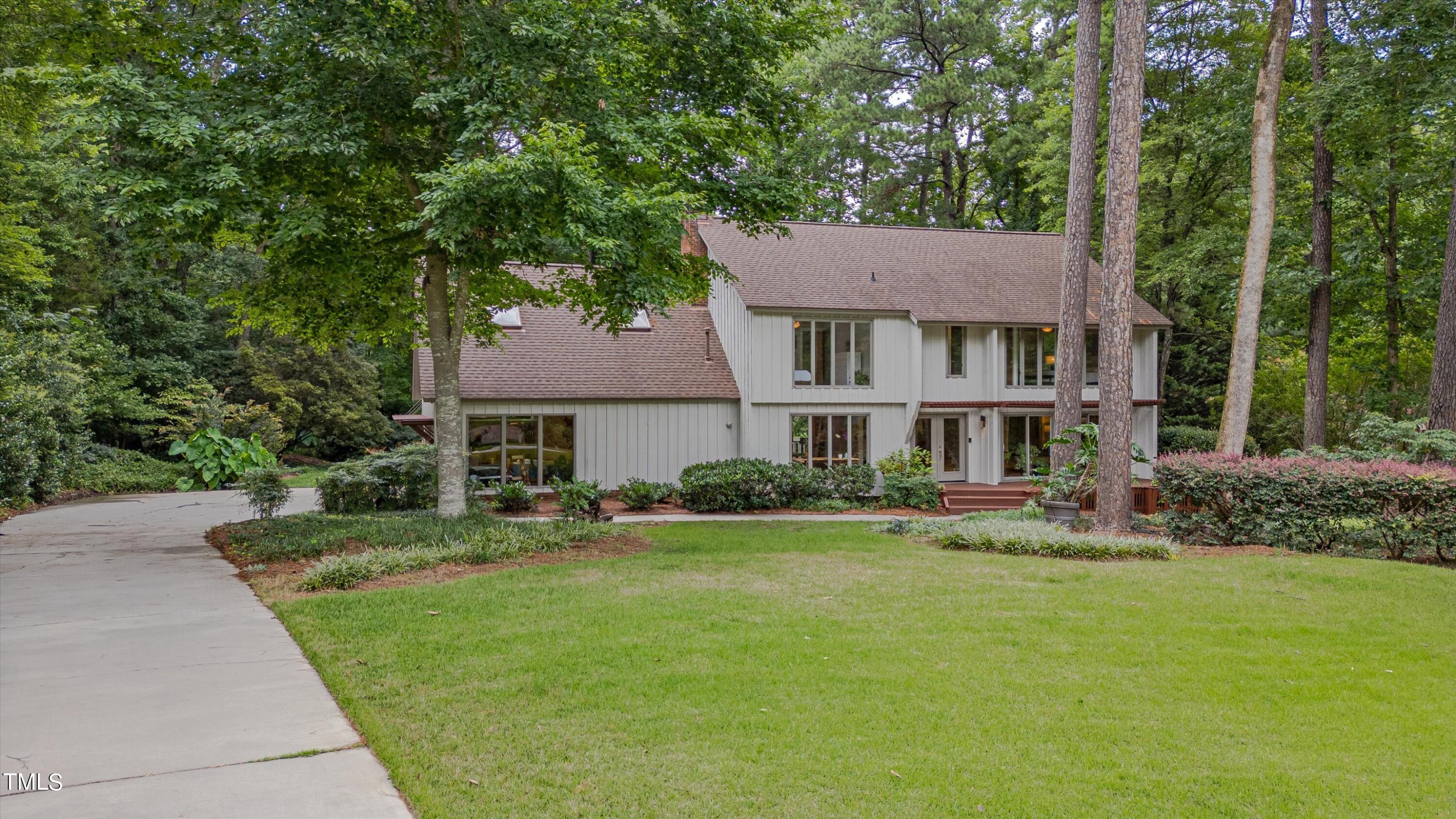 a front view of a house with a garden and yard