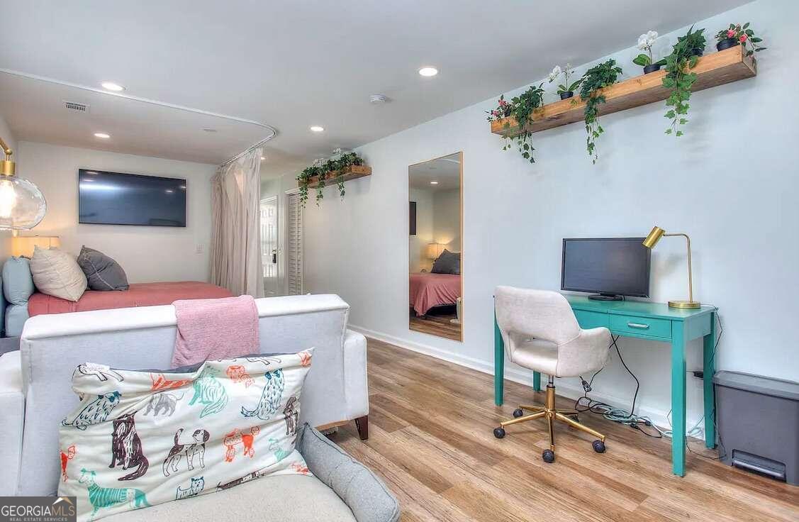 a living room with furniture and a wooden floor