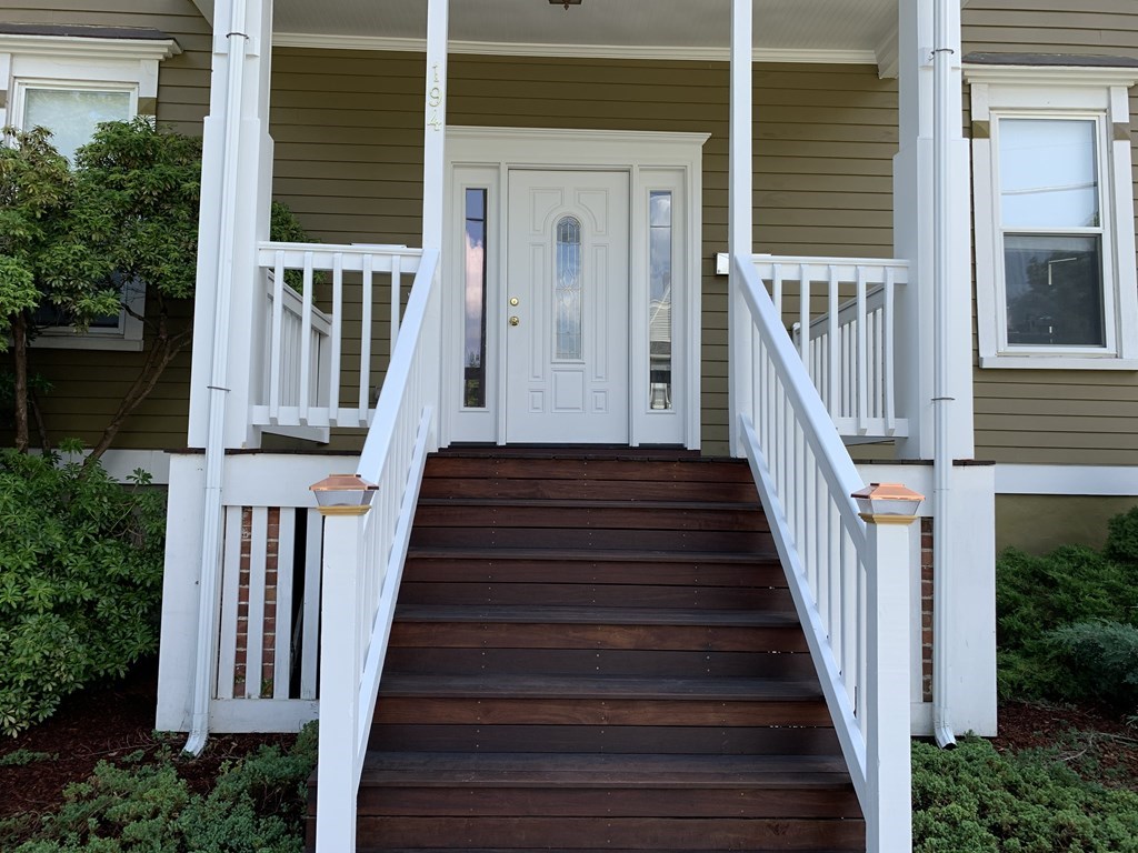 a view of a house with wooden stairs