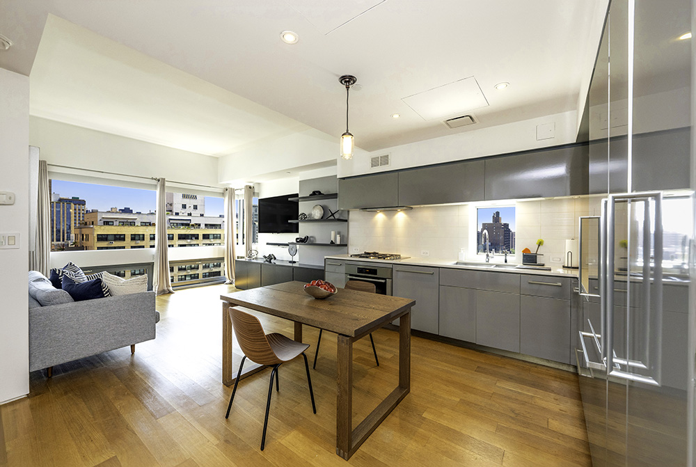 a kitchen with a table chairs refrigerator and microwave