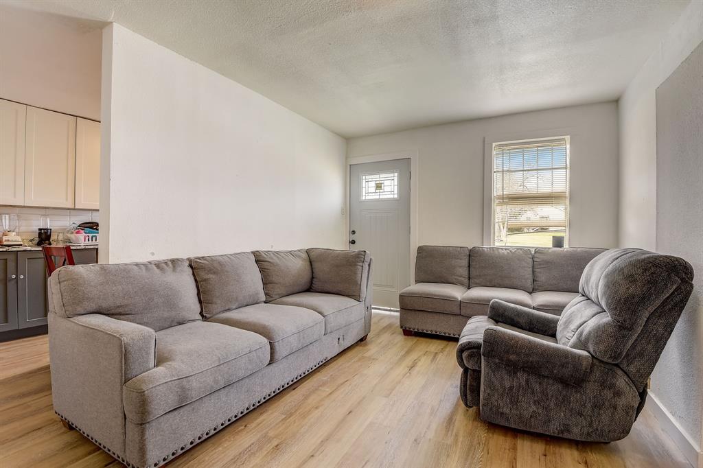 a living room with furniture a couch and a window