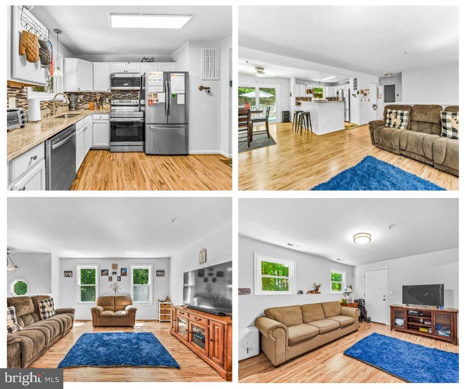 a view of living room kitchen with furniture and wooden floor