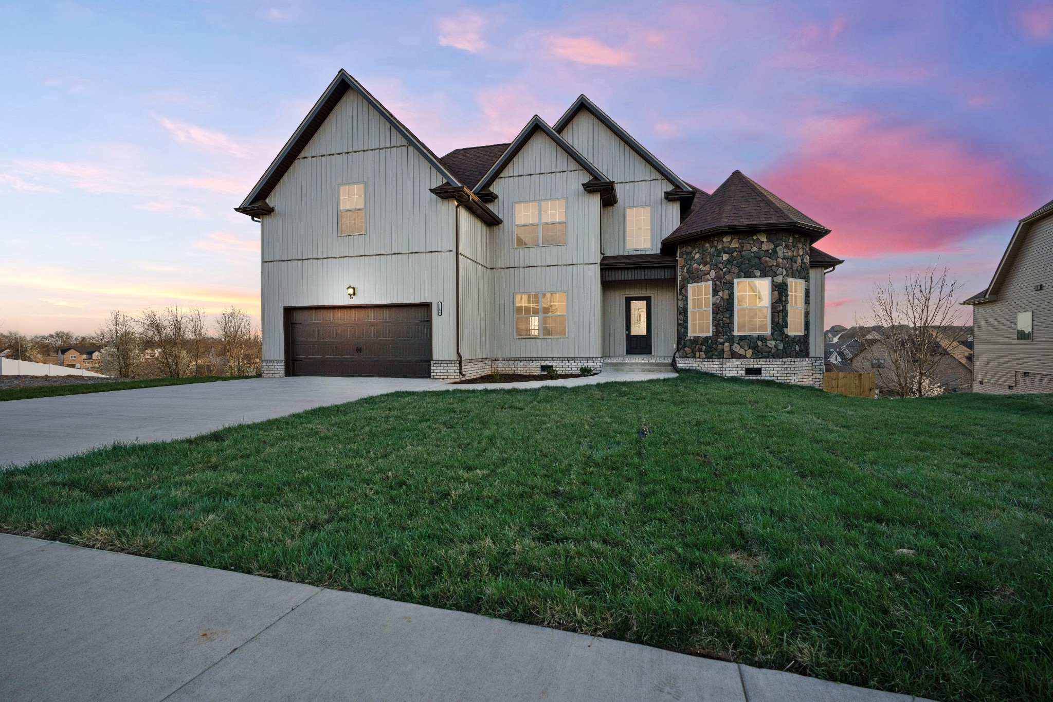 a front view of a house with a garden and yard