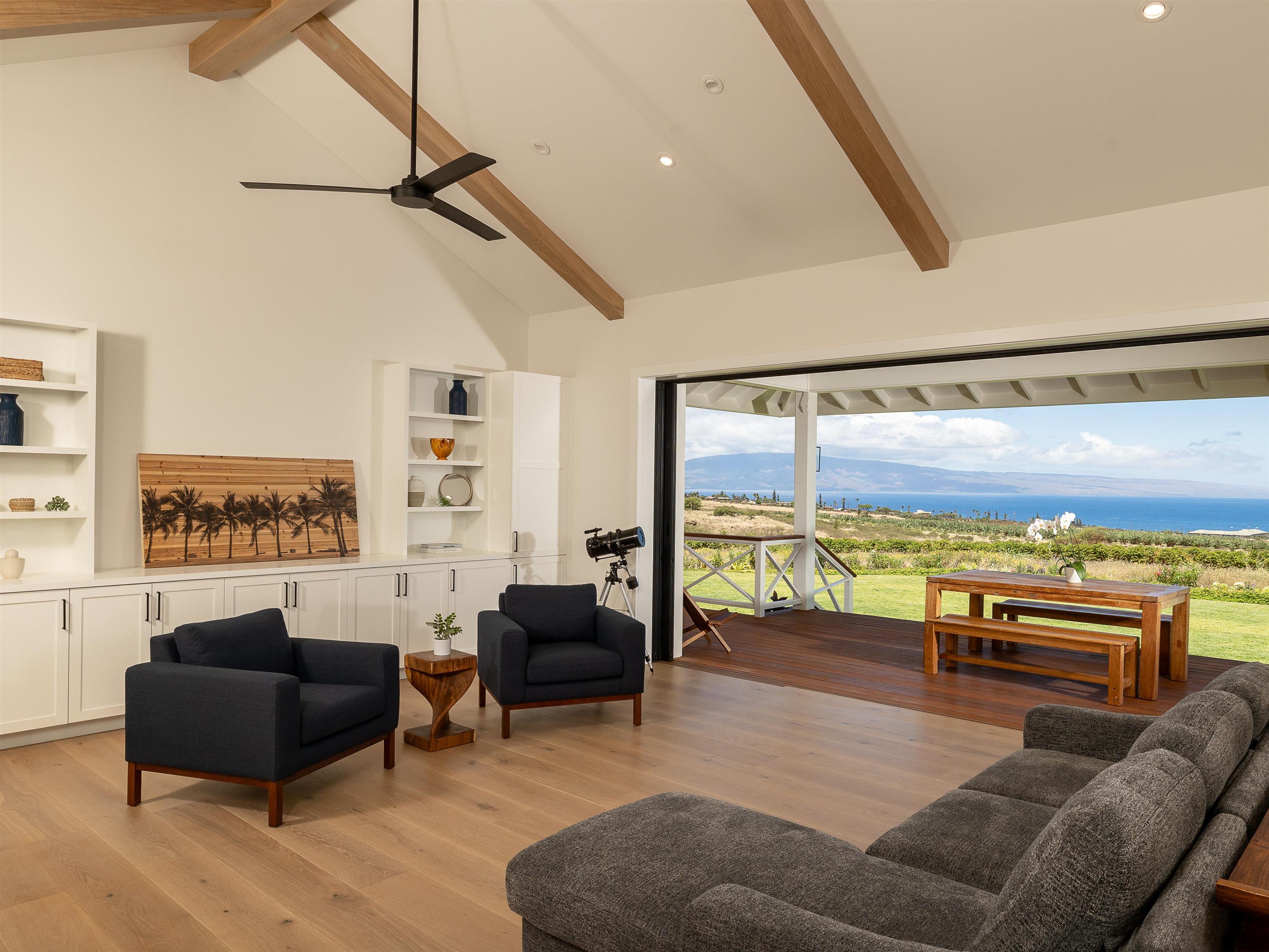 a living room with furniture and a floor to ceiling window