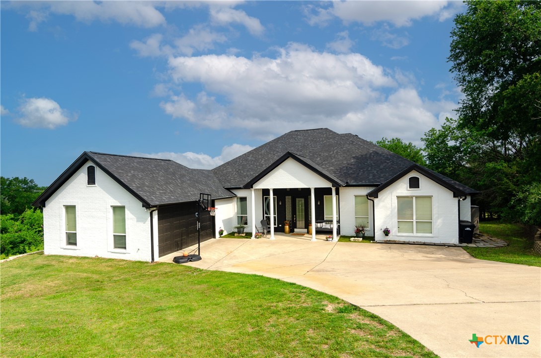 a front view of a house with a garden