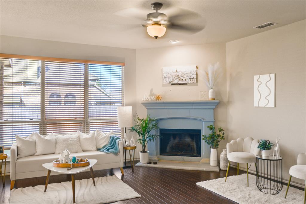 a living room with furniture a window and a fireplace