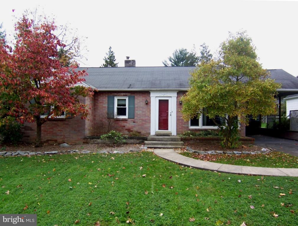 a view of a house with a yard and tree s