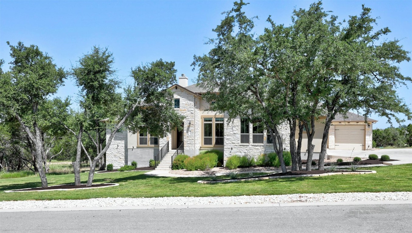 a front view of a house with a garden