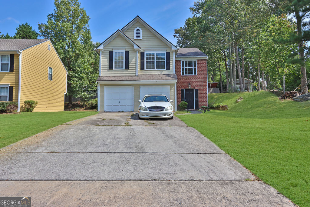 a front view of a house with a yard