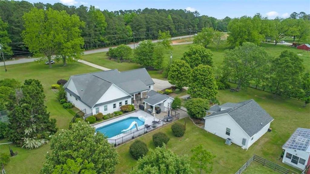 an aerial view of a house with pool outdoor seating and yard