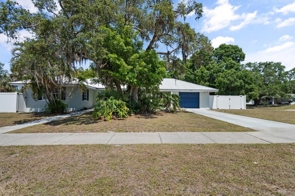 a front view of house with yard and trees