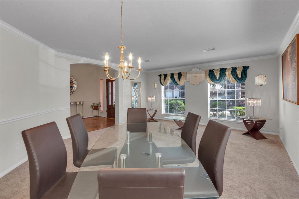 a view of a dining room with furniture wooden floor and chandelier