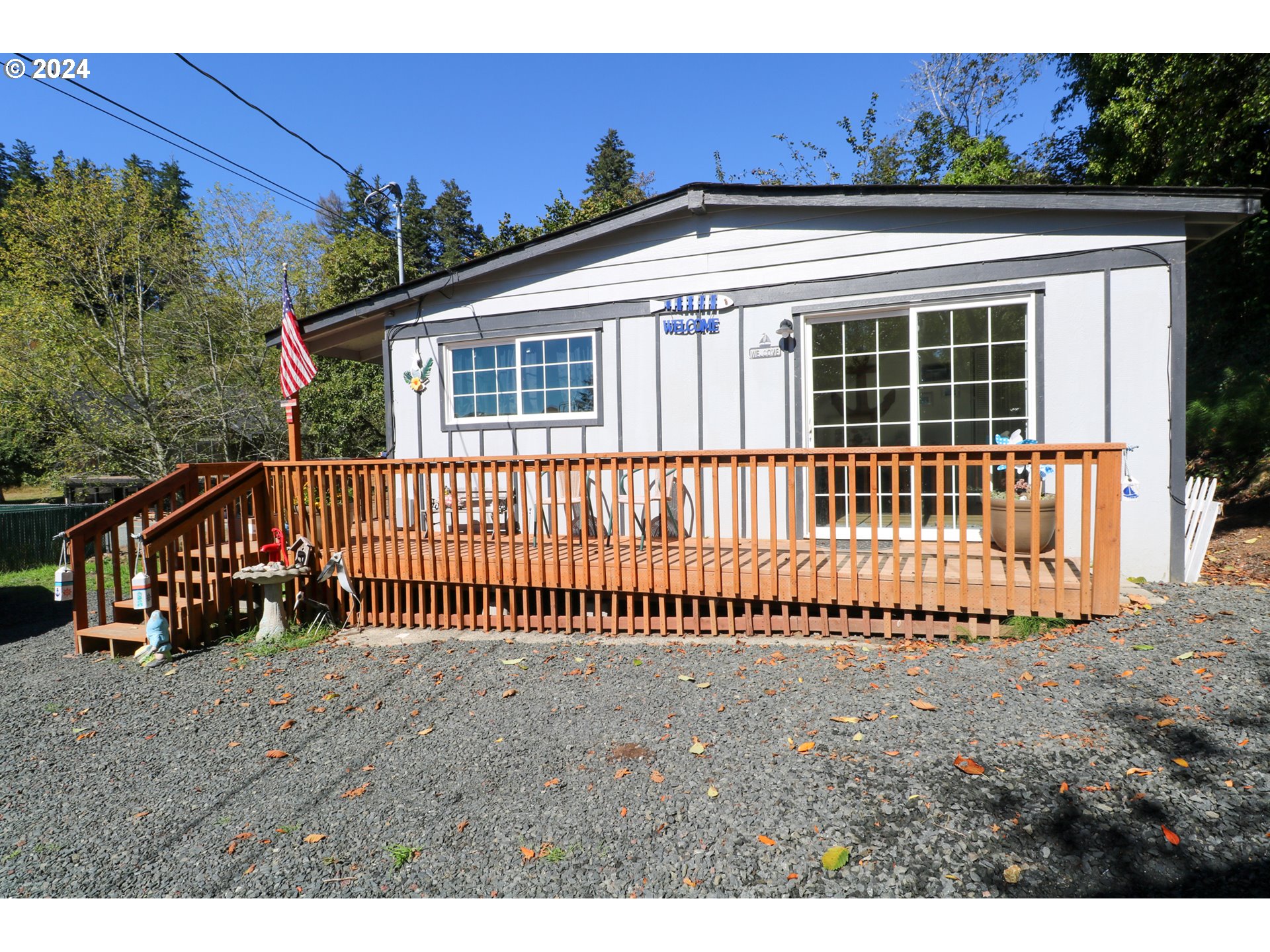 a view of a house with a small yard and wooden fence