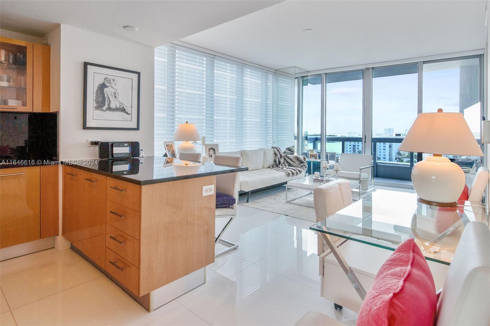 a kitchen with stainless steel appliances kitchen island granite countertop a sink and cabinets