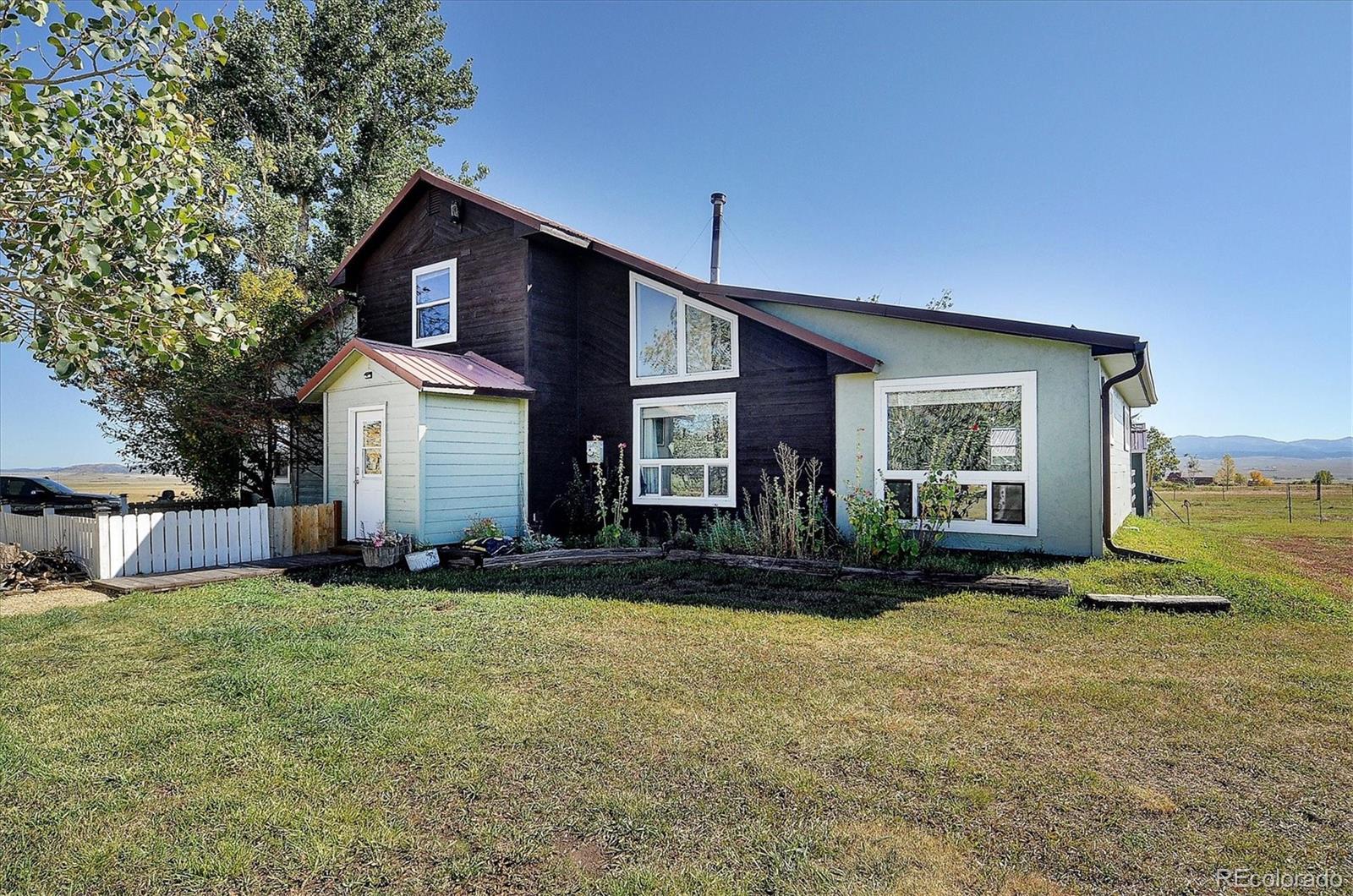 a view of a house with a yard and sitting area