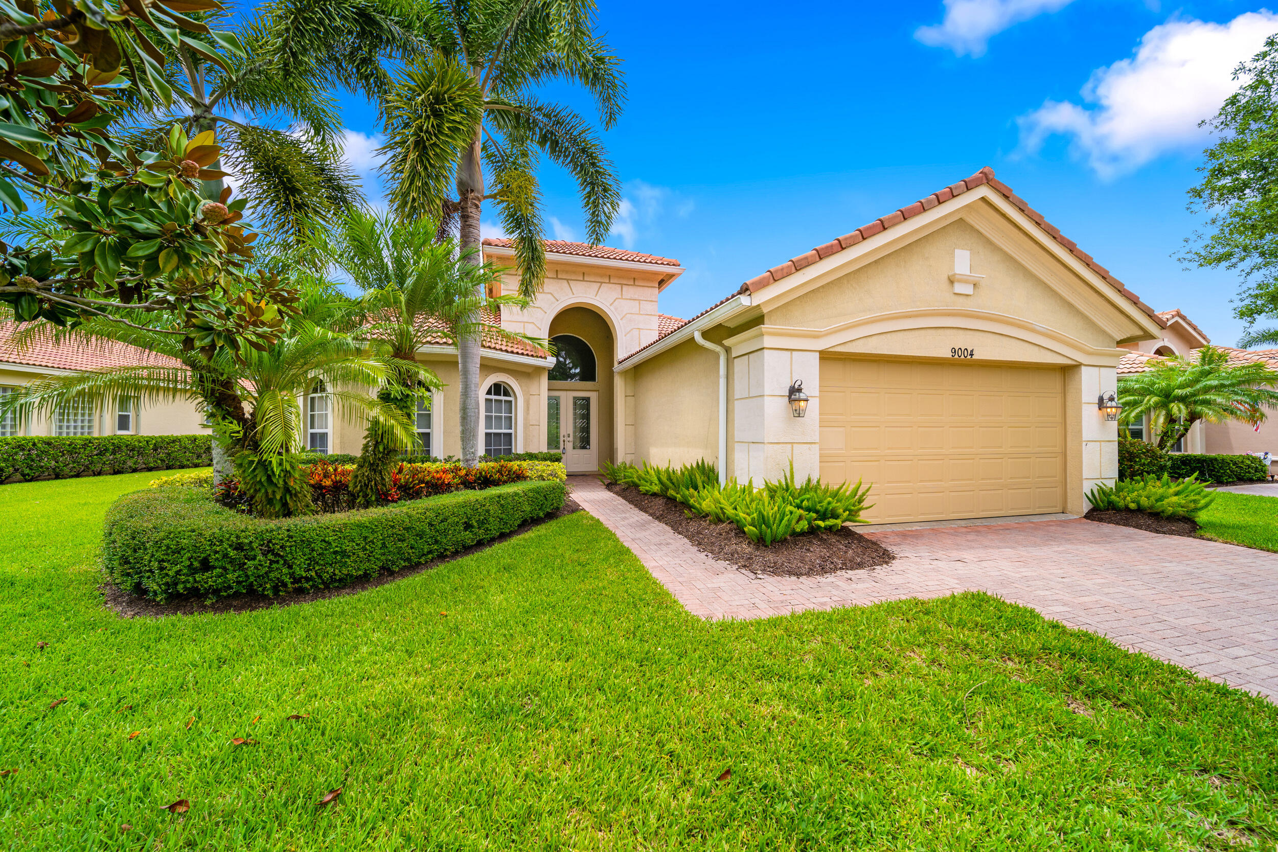 a front view of a house with a yard and garage