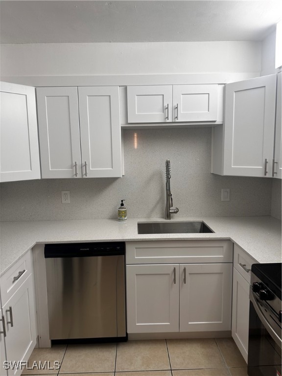 a kitchen with white cabinets and a stove