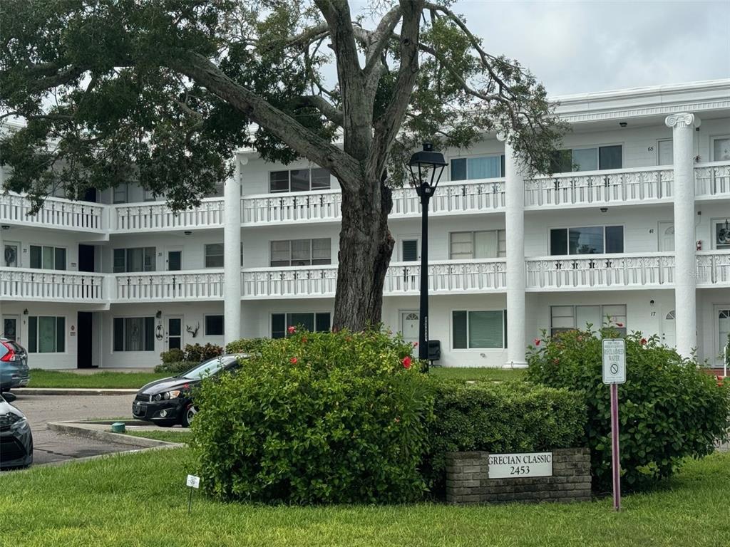 a front view of a residential apartment building with a yard