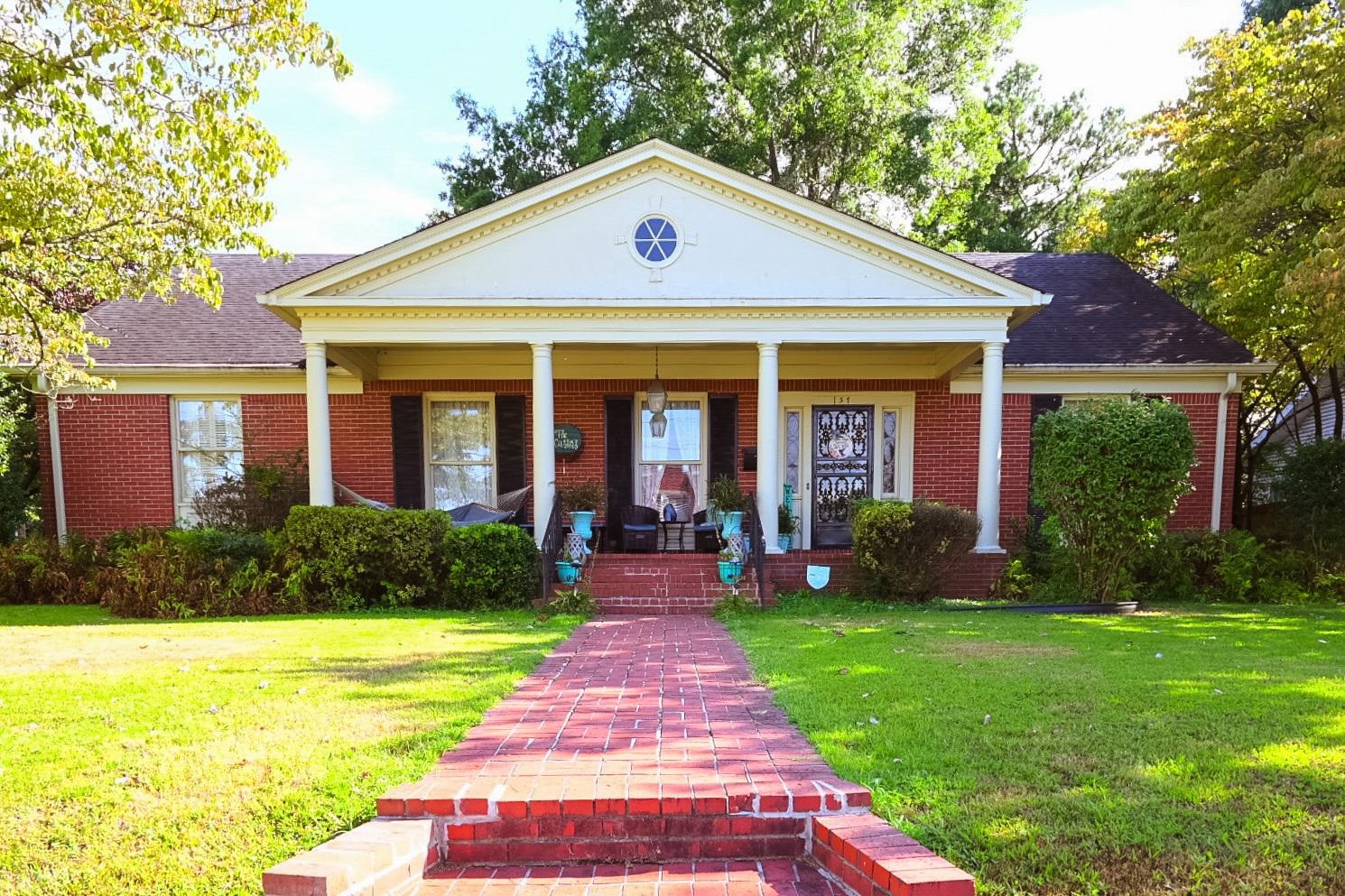 a front view of a house with garden