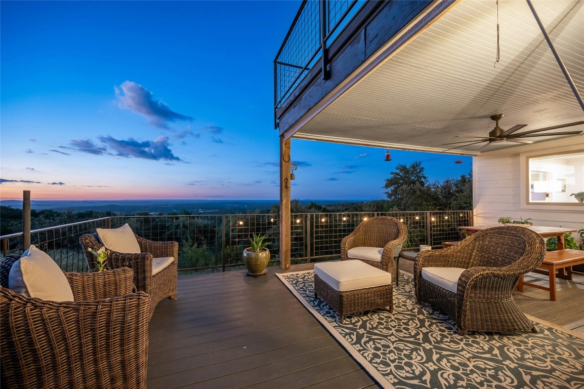 a balcony with furniture and wooden floor