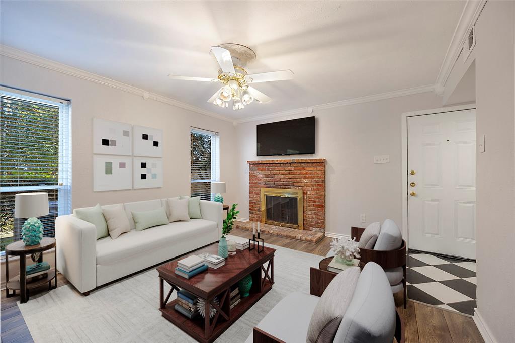 a living room with furniture a fireplace and a flat screen tv