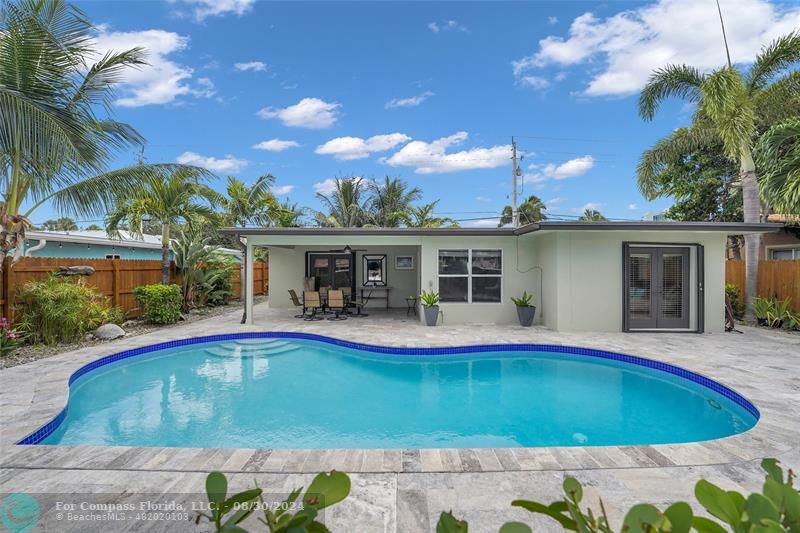 a view of house with swimming pool and porch