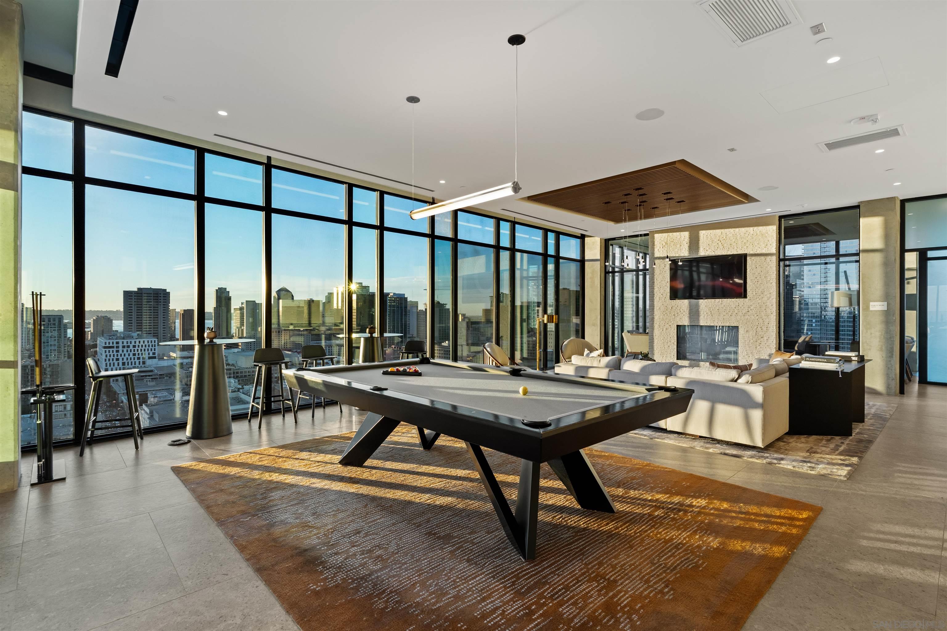 a living room with furniture a table and a large window