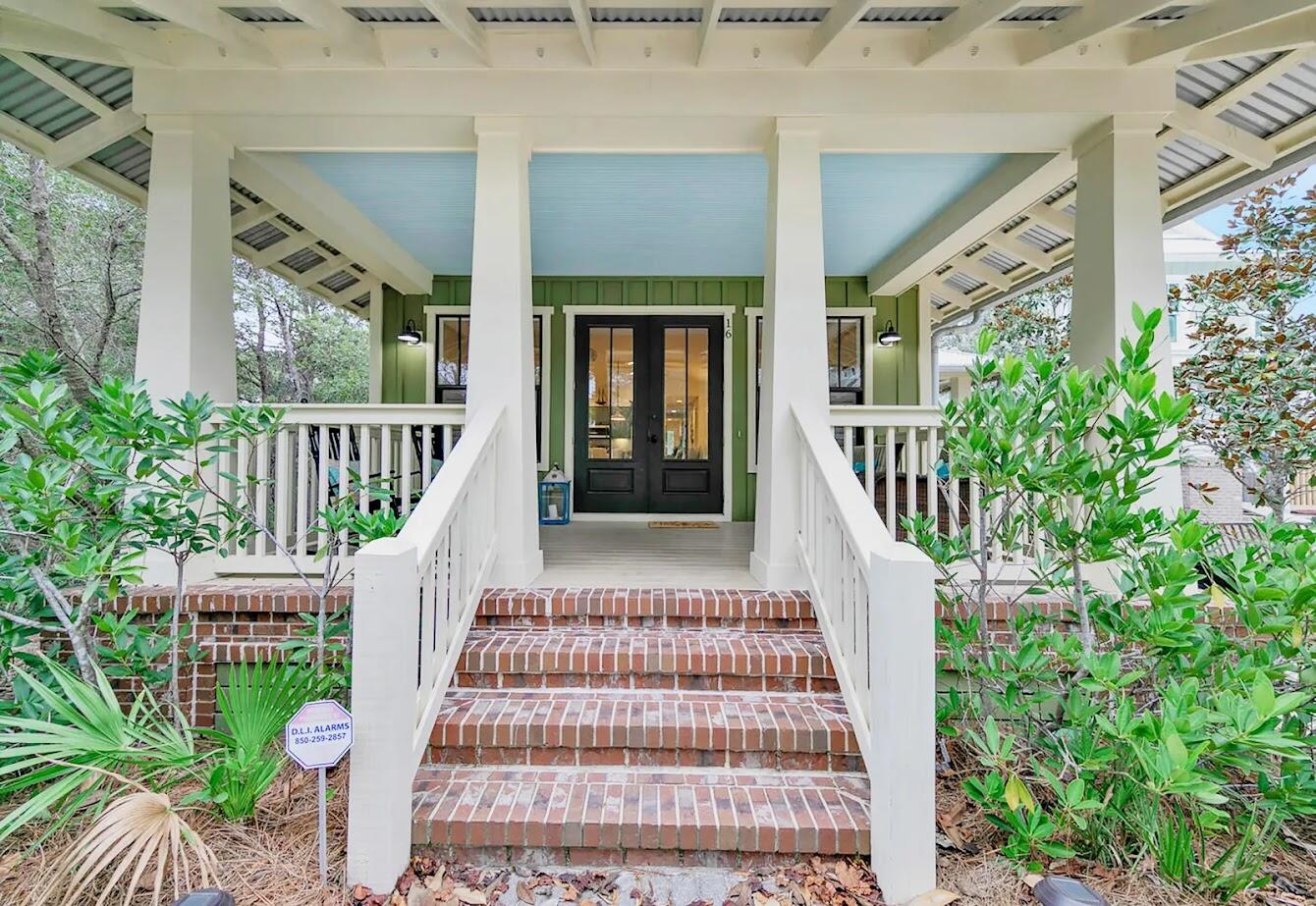 a view of a balcony with chairs and wooden floor