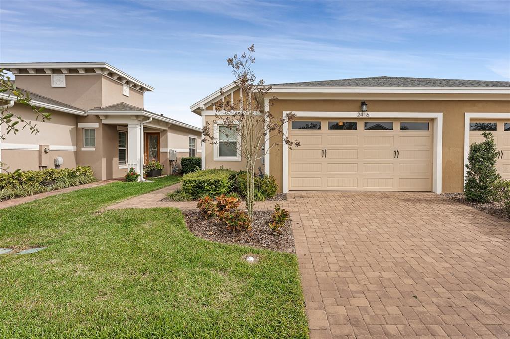 a front view of a house with a yard and garage