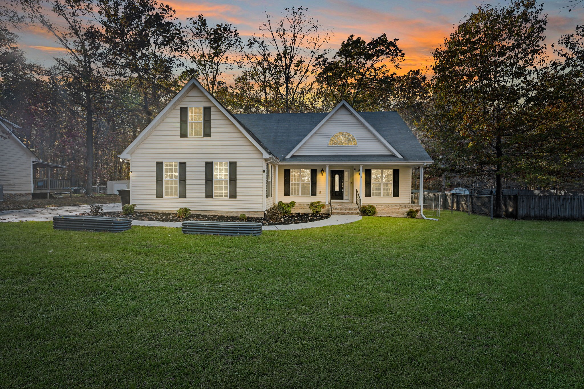 a front view of a house with a garden