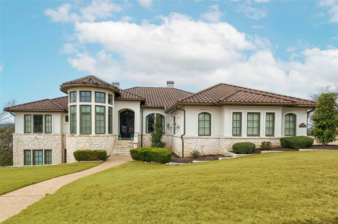 a front view of a house with a garden