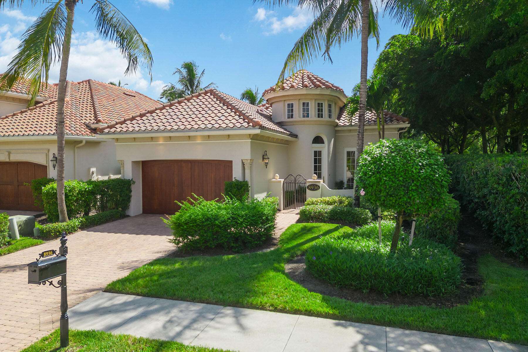 a front view of a house with a garden